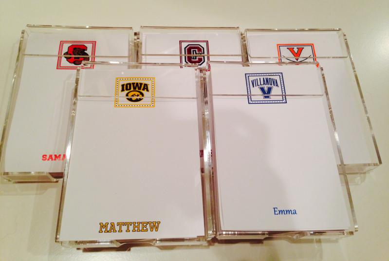 College themed loose sheets of paper in a lucite holder